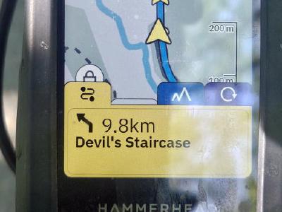 Hammerhead cycling computer mounted on handlebars displaying 9.8km to the Devil's Staircase